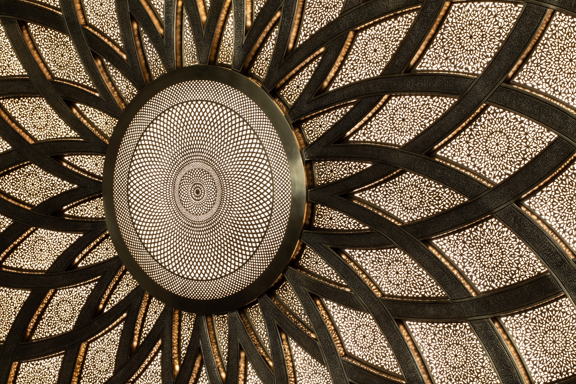 Upward view of a mandala with radiating petal-like ribs around a finely perforated centre, Mandala 818 series.
