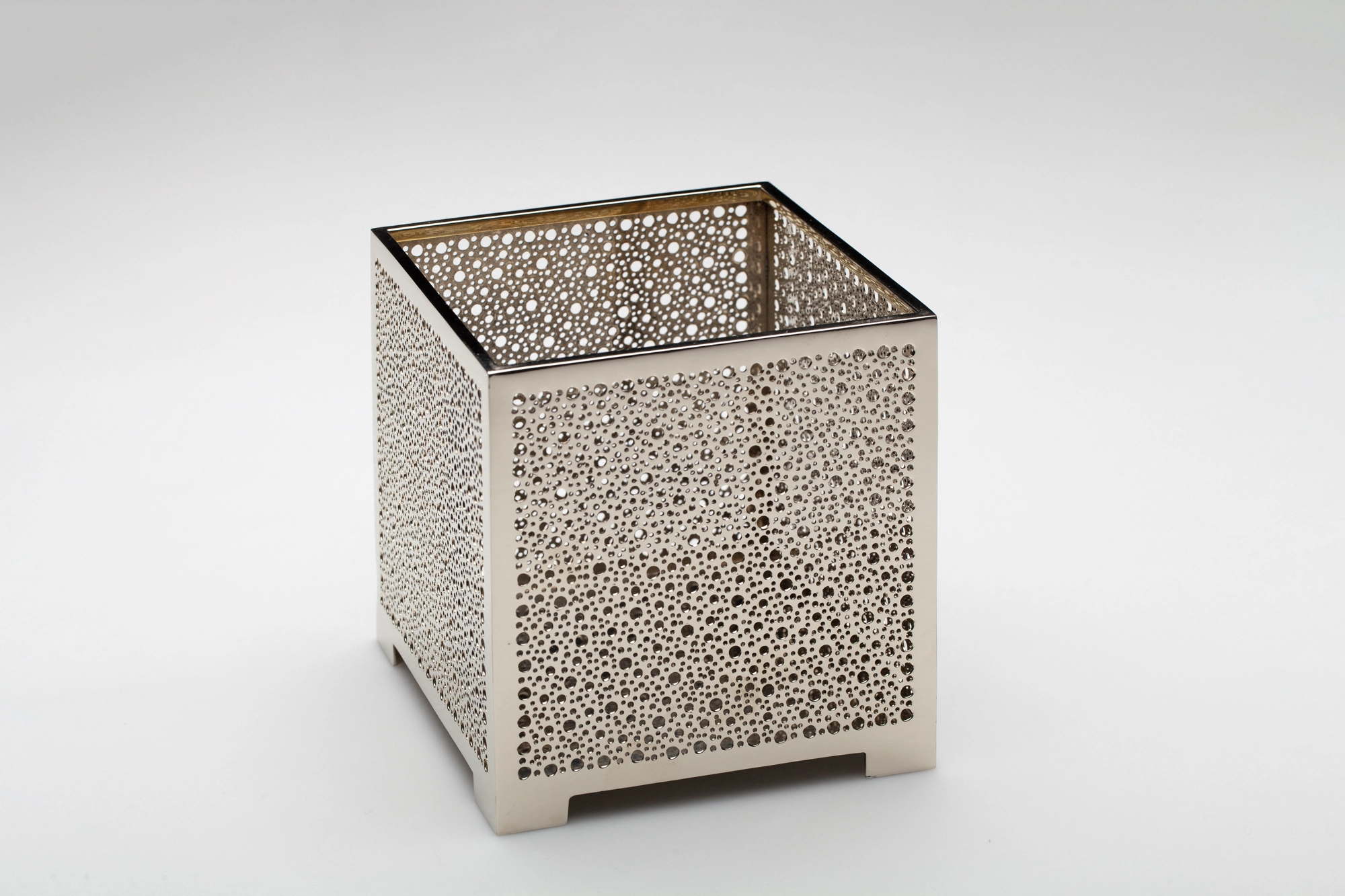 A square pierced metal candle box in a silver finish with fine openwork, shown unlit against a white background.