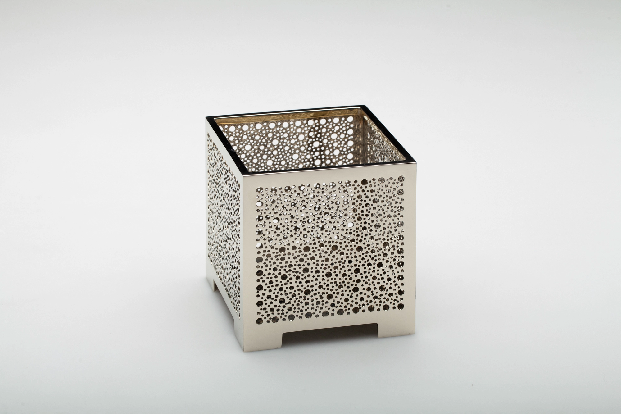A square pierced metal candle box in a silver finish, photographed against a pale grey background.