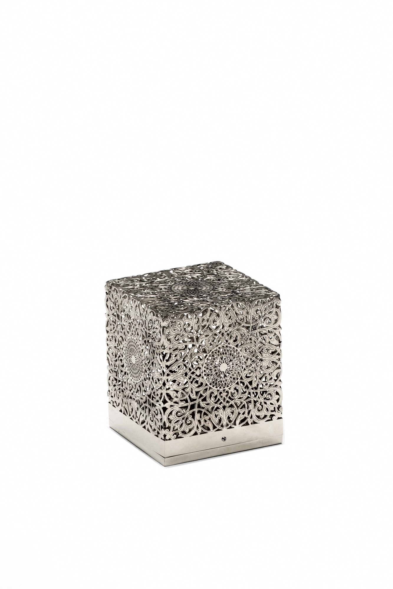 Pierced-silver cube table lamp on a pale base, shown unlit against a white background.