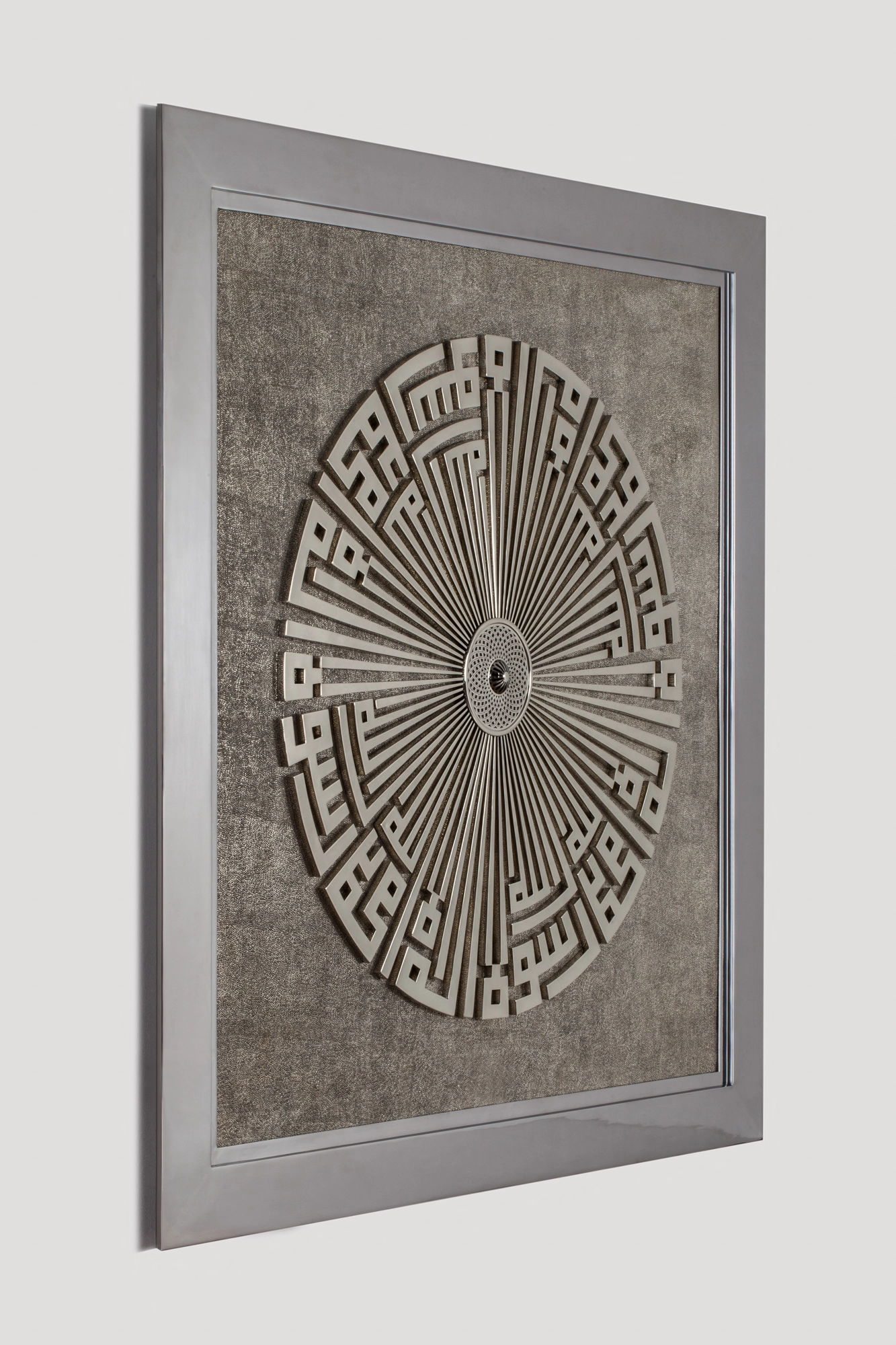 A framed square wall panel with a circular Kufic medallion radiating from the centre, seen at an angle.