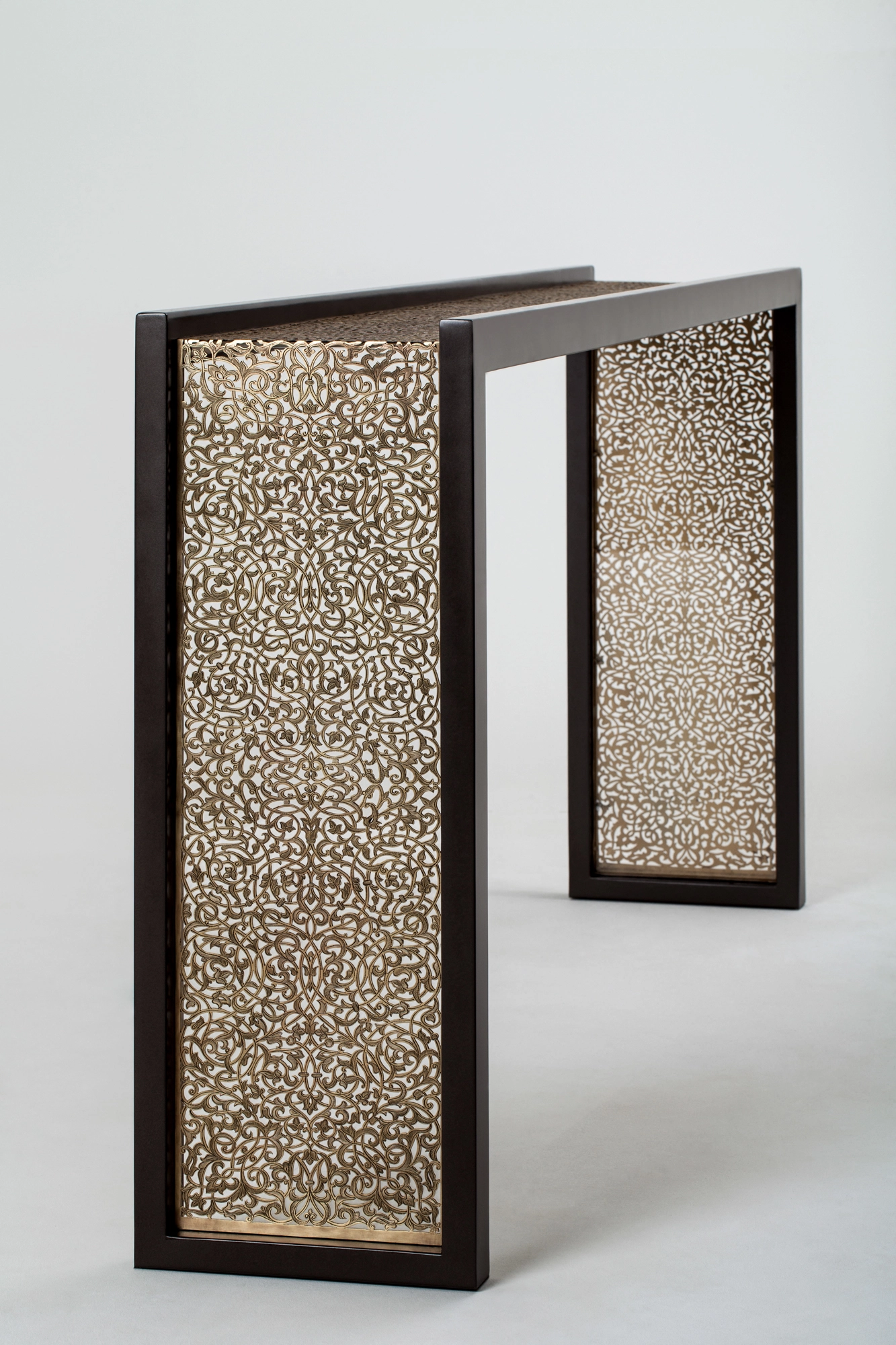 A console table with two pierced metal side panels set in a dark frame, photographed against a white background.