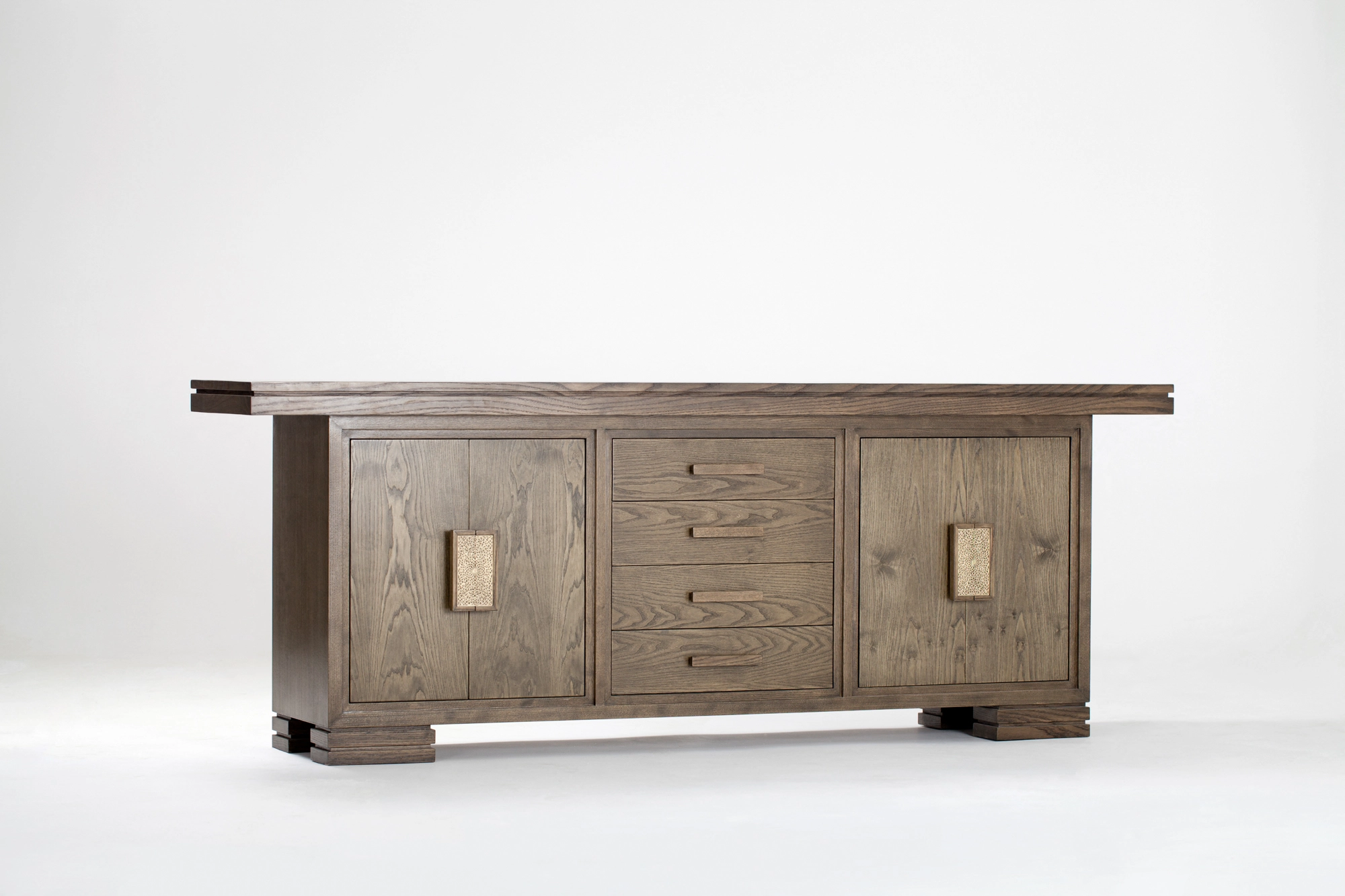 A long low wooden sideboard with central drawers and end cabinets, photographed against a white background.