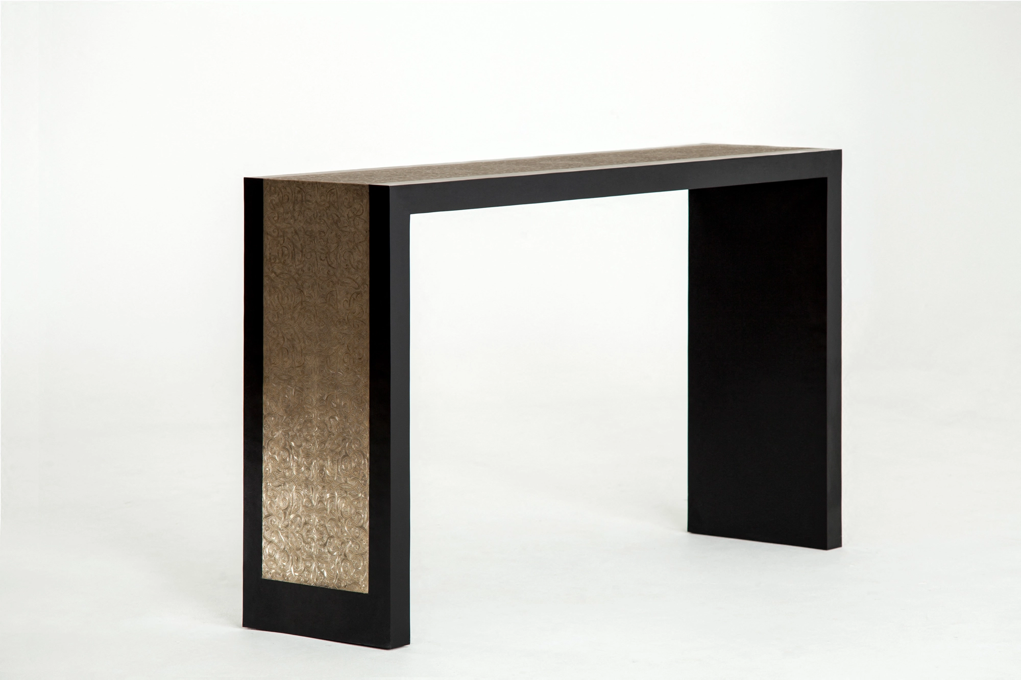 A console table with a dark frame and a woven golden side panel, photographed against a white background.