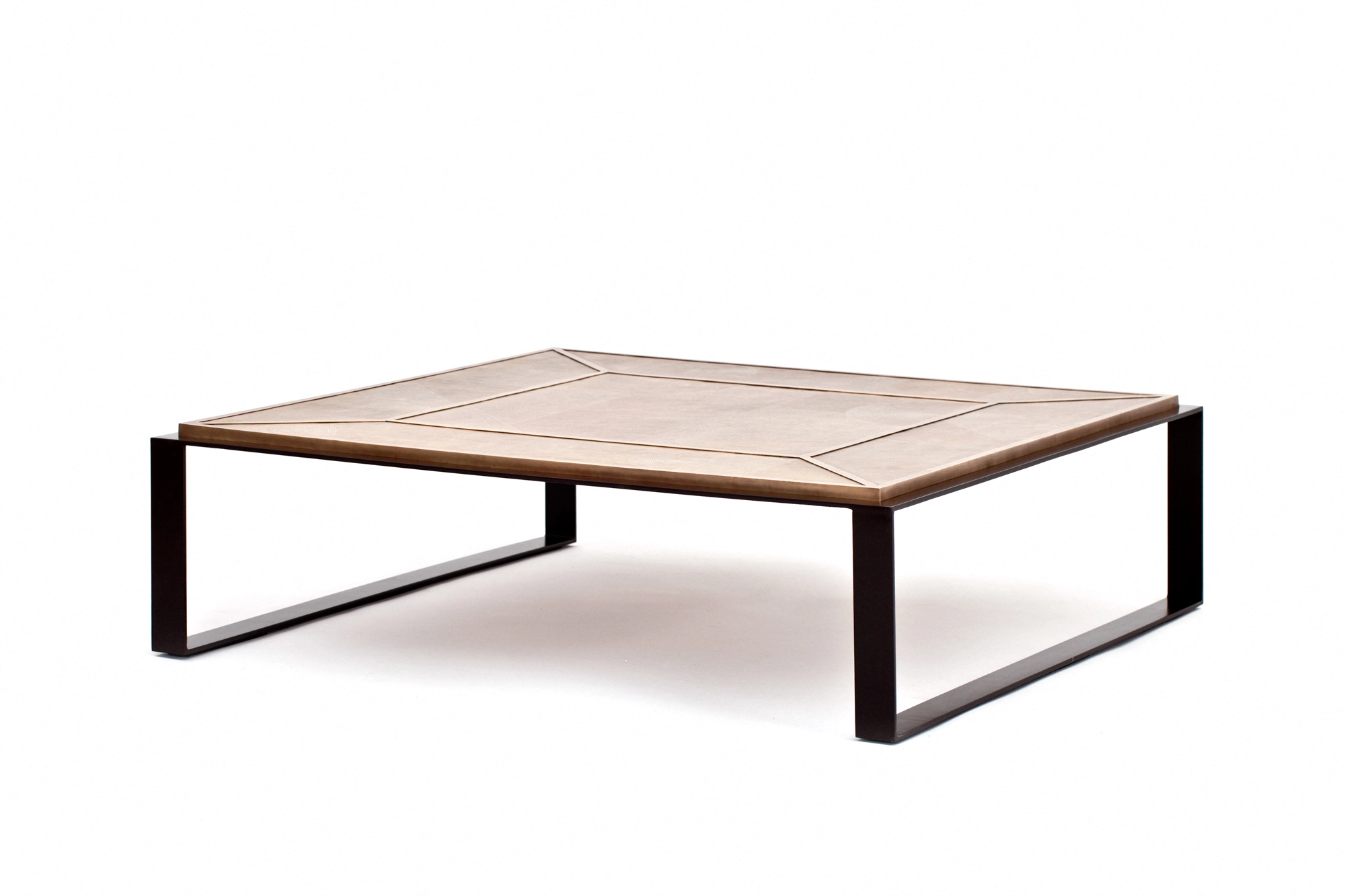 A low square coffee table with a woven top on dark metal sled legs, photographed against a white background.