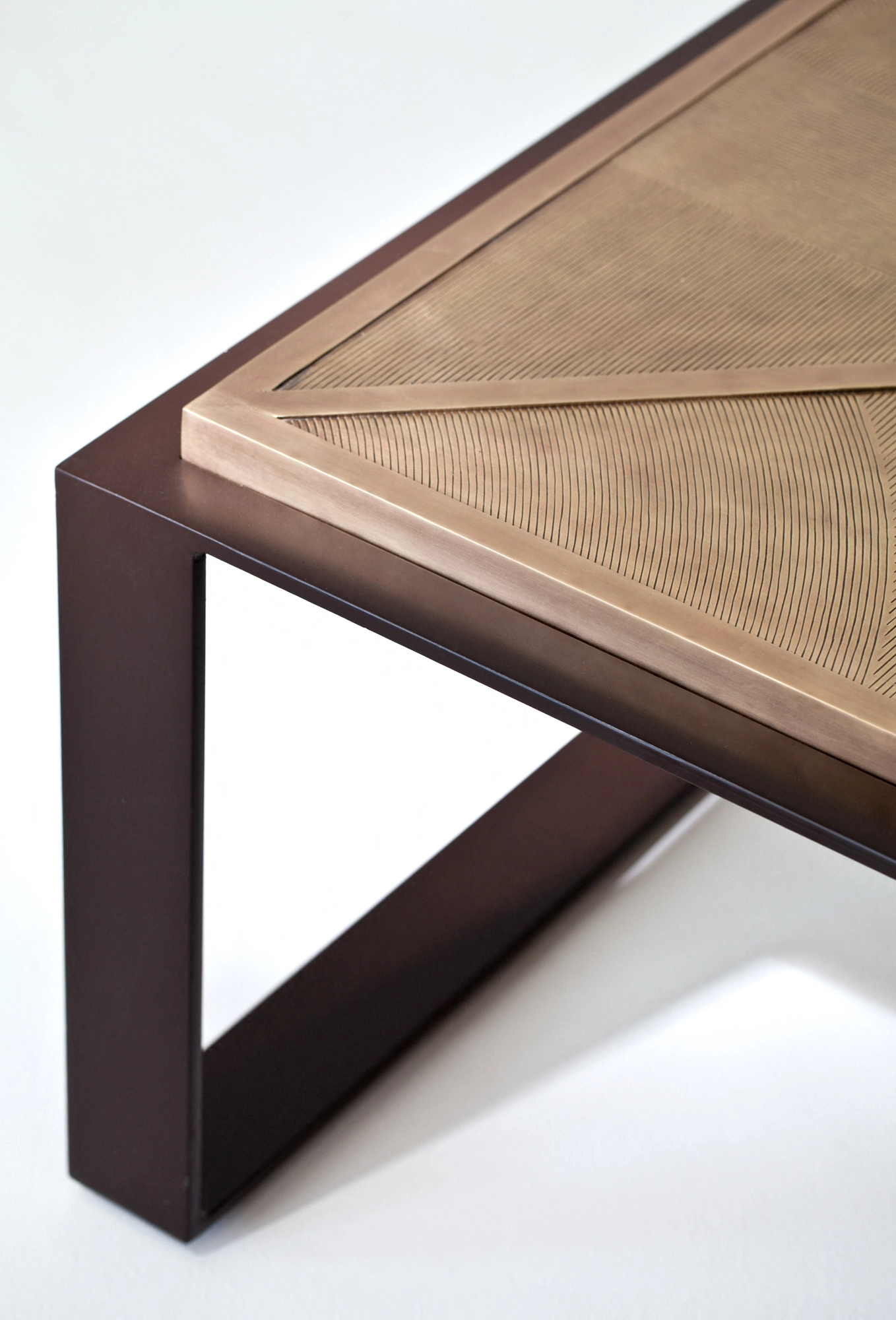 Close-up of a coffee table's woven top corner meeting its dark metal frame leg.